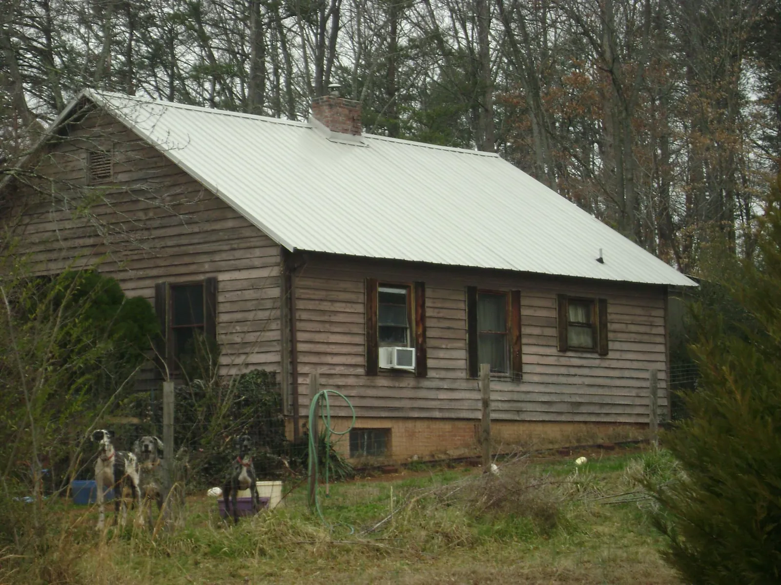 White metal roof on an old wood sided farmhouse, from a Metal Roof Installation job in Mattawa